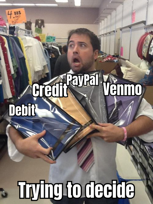 A HUMOROUS IMAGE OF A PERSON SURROUNDED BY CREDIT CARDS AND DIGITAL PAYMENT ICONS, LOOKING OVERWHELMED, WITH THE CAPTION 